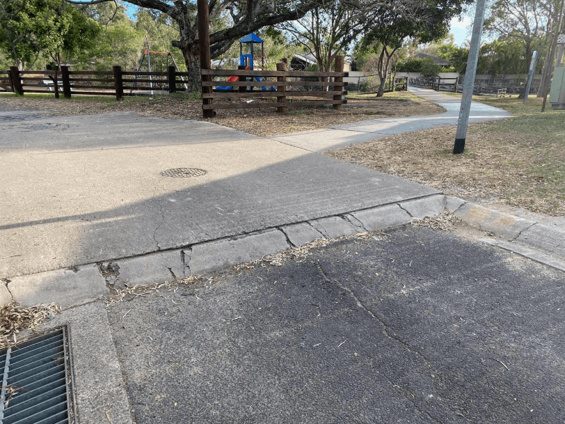 A road with a playground and a fence AI-generated content may be incorrect.