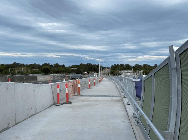 A road with orange and white cones AI-generated content may be incorrect.