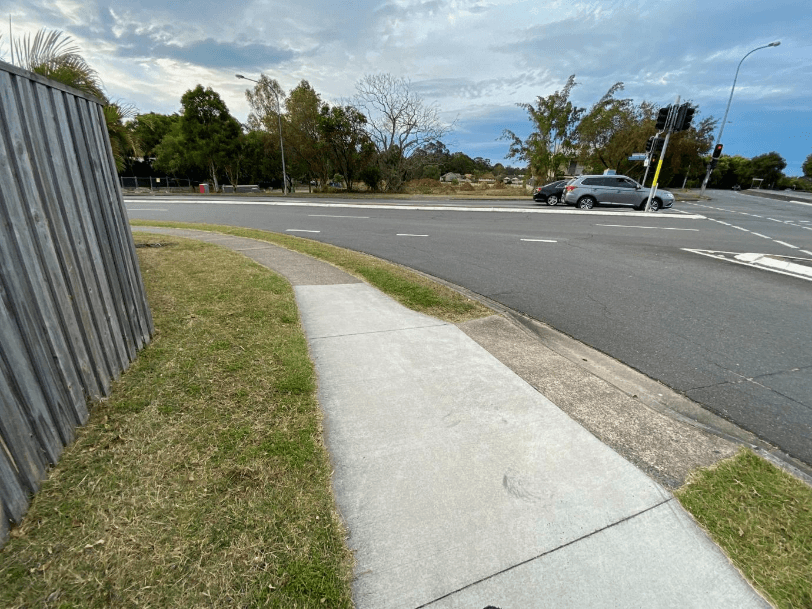 A sidewalk next to a street AI-generated content may be incorrect.