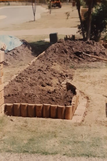 A dirt patch in a yard AI-generated content may be incorrect.